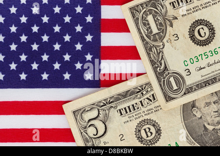 Amerikanische Dollar Bill Banknoten auf einer amerikanischen stars und Stripes Flagge Stockfoto