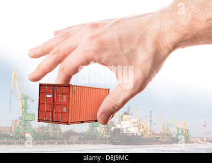 Leuchtend rote Metall Versand Frachtcontainer in die Hand des Mannes über Port Hintergrund Stockfoto