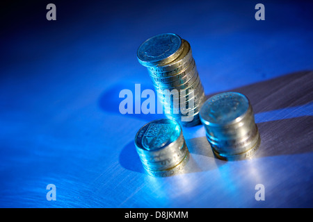 Stirling-Pfund-Münzen gestapelt auf Stahloberfläche gebürstet Stockfoto