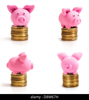 Vier kleine rosa Schweinchen auf Münzen Stockfoto