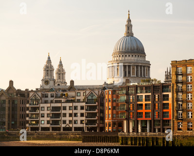 Moderne Wohnungen und Häuser von Themse mit St Pauls Cathedral in London England in der Dämmerung wie die Sonne ist im Himmel niedrig eingestellt. Stockfoto