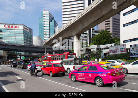 Bangkok Verkehr auf Ratchadamri Road in Richtung Silom Road mit Skytrain verfolgen, Überführung und Büro Buidlings im Blick Stockfoto