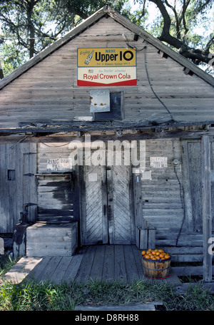Vintage Holz Obstkorb mit frischen Orangen zu verkaufen sitzt auf der Veranda eines rustikalen Store mit Old-Time Soda Pop Zeichen im ländlichen Florida/USA. Stockfoto