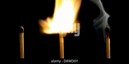 Streichholz brennt auf schwarzem Hintergrund Stockfoto