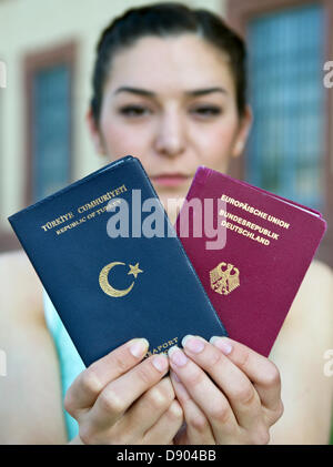 Student Merve Gul präsentiert einen German (R) und einen türkischen Pass in Stuttgart, Deutschland, 7. Juni 2013. Kurz vor einer Sitzung des Bundestages (FPK) auf die Frage der Doppelstaatsbürgerschaft sprach Wirtschaftsminister von Baden-Württemberg für die Gewährung von Menschen mit Migrationshintergrund doppelte Staatsbürgerschaften. Foto: BERND WEISSBROD Stockfoto