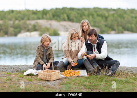 Eltern und 2 Kinder Pilze sammeln Stockfoto