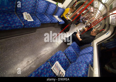 Metro und Stadt Am Gratiszeitungen verworfen und die Londoner u-Bahn-Netz weiterlesen Stockfoto