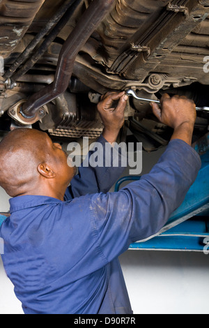 afrikanische amerikanische Mechaniker, die Reparatur eines Autos Stockfoto