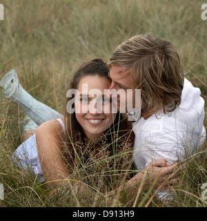 Ein junges Paar in den Rasen, Skane, Schweden liegen. Stockfoto
