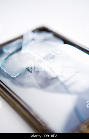 Ein Porträt hinter ein zerbrochenes Glas in einem Rahmen. Stockfoto