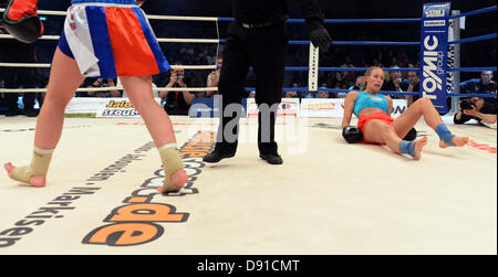 Deutsche kick Boxer Christine Theiss (R) fällt auf den Boden während ihres Kampfes gegen Olga Stavrova aus Russland bei Stekos Fight Night im Circus Krone in München, 7. Juni 2013 statt. Theiss verlor den Kampf und damit auch ihren Weltmeistertitel. Foto: Felix Hoerhager Stockfoto