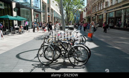 Fahrräder parkten in der 2 Haupteinkaufsstraße von St. David Und Menschen, die im Sommer in Cardiff City Centre Wales einkaufen UK KATHY DEWITT Stockfoto