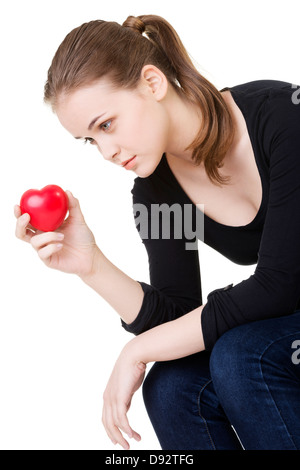 Hübsche Frau in Depression, die mit kleinen Herzen in der Hand. Stockfoto