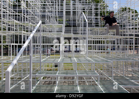 Serpentine Pavillon 2013, London, Vereinigtes Königreich. Architekt: Sou Fujimoto, 2013. Mann auf Schritte. Stockfoto