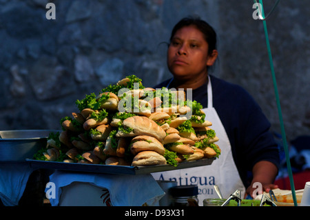 Die guatemaltekische Frau, einem Straßenhändler, verkauft Sandwiches zum "Verbrennen von Festival der Teufel', Antigua, Guatemala. © kraig Lieb Stockfoto