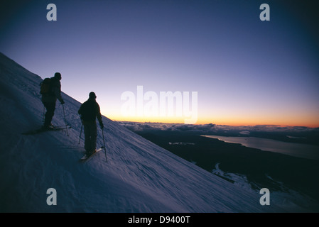 Zwei Skifahrer stehen auf die Oberseite eines Berges bewundern die Aussicht, Chile. Stockfoto