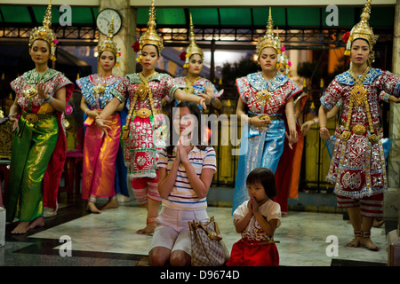 Gläubigen in den Erawan-Schrein, Bangkok mit traditionellen Tänzern Stockfoto