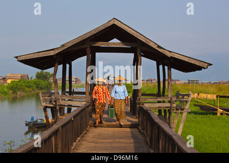 Birmanisch verwenden die angehobenen Gehweg in der Nähe des Dorfes MAING THAUK auf dem Weg zum Wochenmarkt - INLE-See, MYANMAR Stockfoto