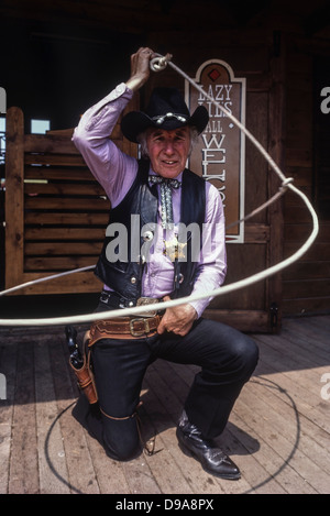 Rex Roper, die Cowboy-Sheriff-Figur, die im American Adventure Theme Park, Ilkeston, Derbyshire, England, Großbritannien, ein Lasso wirft. Ca. 1980 Stockfoto