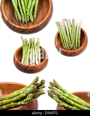 frischer grüner Spargel in Holzschale isoliert auf weißem Hintergrund Stockfoto