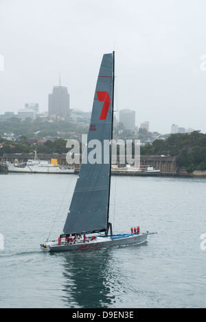 Maxi Yacht Wild Oats XI im Hafen von Sydney an einem nebligen Morgen, mit North Sydney im Hintergrund. Stockfoto