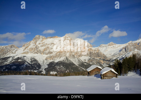 Reittiere Lavarella und Conturines hinter ein paar Scheunen im Skigebiet Alta Badia in der Nähe von Corvara, Dolomiten, Südtirol, Italien Stockfoto