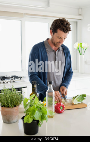 Mann Hacken Gemüse in der Küche Stockfoto