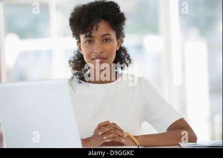 Porträt einer Frau sitzt vor einem laptop Stockfoto