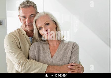 Mann umarmt seine Frau von hinten Stockfoto