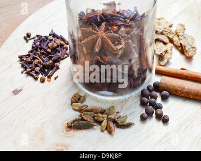 Glasflasche mit set Gewürze für Glühwein auf Holztisch Stockfoto