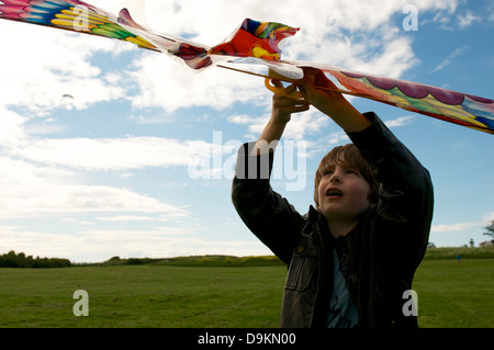 Junge lernt einen Drachen zu fliegen Stockfoto