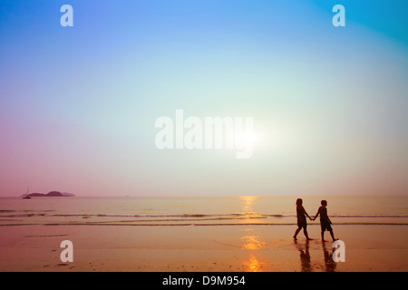 Silhouetten von paar am Strand bei Sonnenuntergang Stockfoto