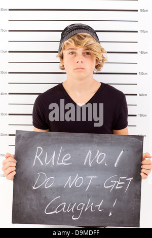 Teen Junge hält eine Tafel kriminellen Fahndungsfoto Stockfoto