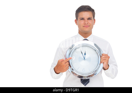 Geschäftsmann hält eine Uhr Stockfoto