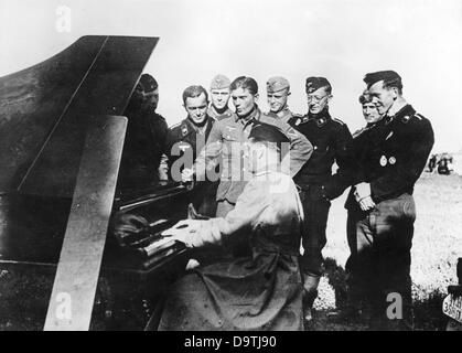 Die Nazi-Propaganda! Auf der Rückseite des Bildes steht: "An der Ostfront. Panzersoldaten retteten ein deutsches Klavier aus einem brennenden Haus und feierten eine sonntagmorgen-Party unter freiem Himmel." Bild von der Ostfront, 20. Juli 1942. Der Angriff des Deutschen Reiches auf die Sowjetunion wurde im Juli 1940 beschlossen und seit Dezember 1940 als "Operation Barbarossa" vorbereitet. Am 22. Juni 1941 begann die Invasion der deutschen Wehrmacht. Fotoarchiv für Zeitgeschichte Stockfoto