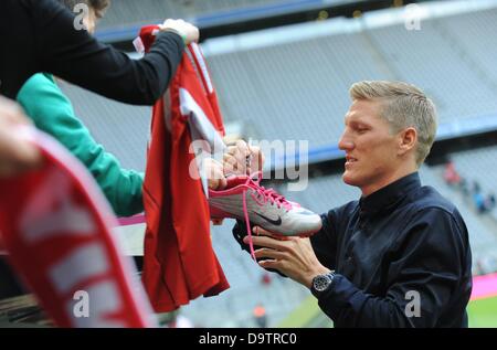 FC Bayern Bastian Schweinsteiger gibt Autogramme nach der diesjährigen ersten Trainingseinheit im Allianz Arena in München, 26. Juni 2013. Foto: ANDREAS GEBERT Stockfoto