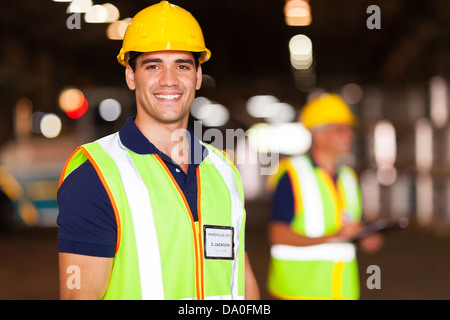 Porträt von lächelnden jungen Lagerarbeiter im Innenbereich Stockfoto
