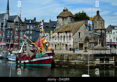 Altes Fischerboot am alten Hafen (Vieux Bassin), vor der Lieutenance (mittelalterliche Gebäude). Normandie, Calvados, Frankreich. Stockfoto