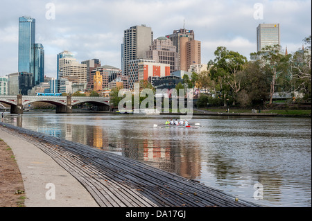 Ruderer trainieren entlang des Yarra River in der Nähe der Princes Bridge in zentraler Geschäft Bezirk von Melbourne, Australien. Stockfoto