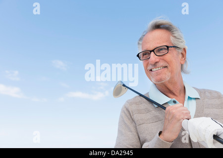 Senior woman Holding Golfclub Stockfoto