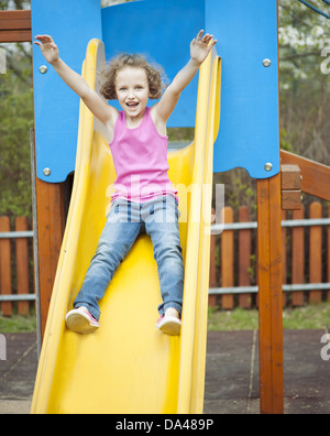 Junges Mädchen auf Folie auf Spielplatz Stockfoto