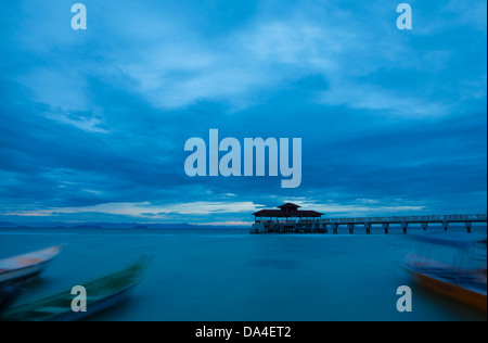 Boote und Pier in der Abenddämmerung Coral Bay, Perhentian Inseln, Terengganu, Malaysia Stockfoto