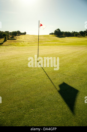 Golfflagge in hellem Grün Grün mit Blau des Meeres im Hintergrund. Stockfoto