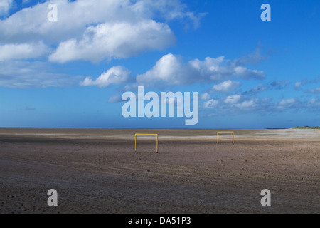 Zwei orange Fußball Torpfosten stehen allein auf eine große offene weite des Strandes Erstellen eines Bildes mit einer surrealen Qualität Stockfoto