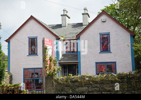 Grafikfenster in leerstehenden Läden, Pubs und Häuser in der Stadt Bushmills, County Antrim, die Trostlosigkeit der Rezession zu lindern. Stockfoto