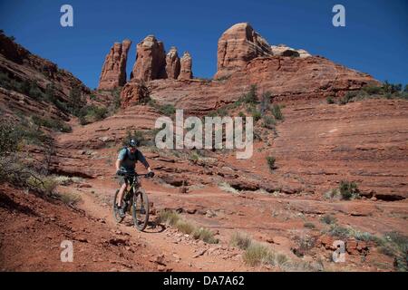 9. Juni 2013 - Sedona, Arizona, USA - Fahrradtouren Mountainbiker seine auf roten Slickrock HiLine unterwegs in Sedona. Sedona Hauptattraktion ist eine Reihe von roten Sandstein-Formationen, die zu glühen in leuchtende Orange und rot, wenn der Aszendent oder untergehende Sonne beleuchtet erscheinen. Die roten Felsen bilden eine beliebte Kulisse für zahlreiche outdoor-Aktivitäten von spirituellen Bestrebungen bis hin zu den Hunderten von Wander- und Mountainbike-Strecken. Sedona war benannt nach Sedona Arabelle Miller Schnebly (1877âˆ "1950), die Ehefrau von Theodore Carlton Schnebly, die Stadt erste Postmeister. (Bild Kredit: Â © Ruaridh S Stockfoto