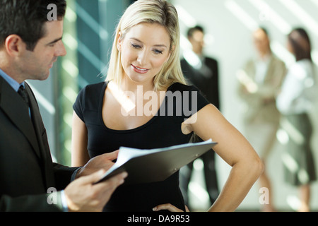 Geschäftsmann und Geschäftsfrau sucht das Dokument in office Stockfoto