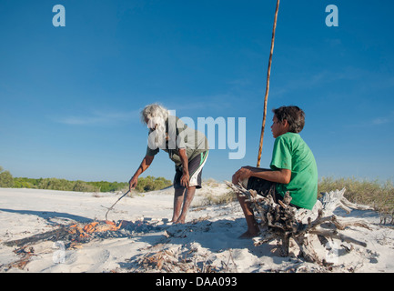 Aborigine-Führer Brian Lee und einheimischen jungen am Lagerfeuer im Hinterland von Cape Leveque Schlamm Krabben zu kochen Stockfoto