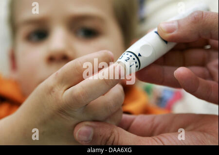 Ein Datei-Bild vom 13. Mai 2005 zeigt ein Blutzucker-Messgerät mit Finger eines Kindes in einem Krankenhaus in Frankfurt am Main, Deutschland. Für Kinder wird mit Diabetes führt zu einem massiven Stress diagnostiziert. Nicht nur müssen sie verstehen, was die Diagnose für ihr zukünftiges Leben bedeutet, sie sind auch durch ihre soziale Umwelt ORKB Kinderpsychologe Bela Bartus anders behandelt. Foto: Frank Stockfoto