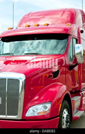 Frau-LKW-Fahrer in der Kabine eines roten semi-LKW Stockfoto